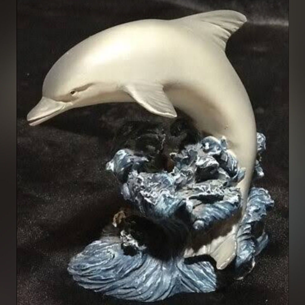 Bottlenose dolphin on a Blue Wave. By Ocean Russ. Ceramic
